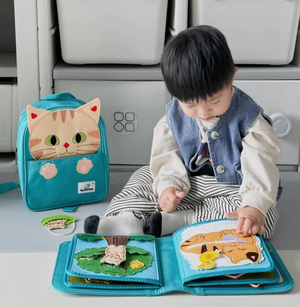Baby playing with My First Book Lucky Cat busy book, engaged in the Montessori inspired play and sensory activities. Makes a great baby gift.