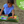 toddler in blue shirt playing with colorful MyFirstBook fabric busy book on ground