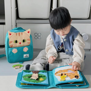 Baby playing with My First Book Lucky Cat busy book, engaged in the Montessori inspired play and sensory activities. Makes a great baby gift.
