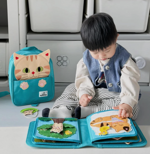 Baby playing with My First Book Lucky Cat busy book, engaged in the Montessori inspired play and sensory activities. Makes a great baby gift.
