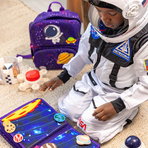 Boy dressed as an outer space astronaut playing with My First Book Space busy book, engaged in the Montessori inspired play and sensory activities. Makes a great baby gift.
