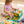 A serene scene of a girl quietly exploring the My First Book Lucky Cat busy book, with sensory features and Montessori-inspired design, her cat-themed backpack resting by her side. An ideal gift for babies.